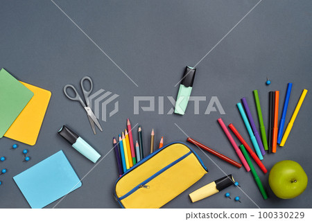 Flat lay photo of workspace desk with school accessories or office supplies on gray background. Flat lay photo of workspace desk with school accessories or office supplies on gray background. 100330229