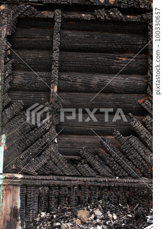 Burned wooden house, devastated construction 100330657