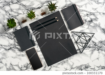 Top view in focus with different office equipment, supplies, stationery. Marble table with copy space. Education, workplace background. Close-up. 100331170