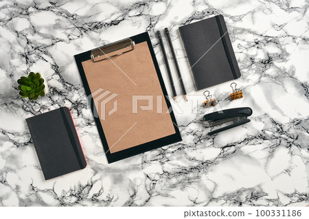 Top view in focus with different office equipment, supplies, stationery. Marble table with copy space. Education, workplace background. Close-up. 100331186