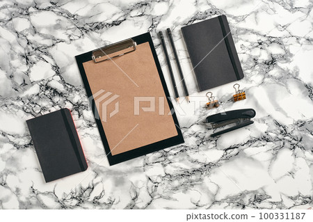 Top view in focus with different office equipment, supplies, stationery. Marble table with copy space. Education, workplace background. Close-up. 100331187