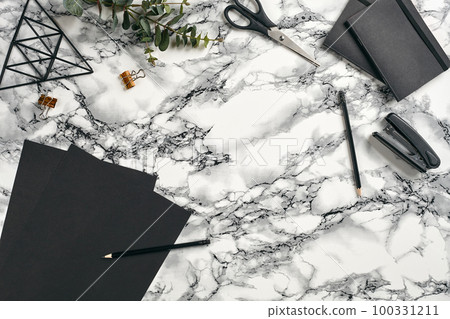 Top view in focus with different office equipment, supplies, stationery. Marble table with copy space. Education, workplace background. Close-up. Top view in focus with different office equipment, supplies, stationery. Marble table with copy space. Education, workplace background. Close-up. 100331211