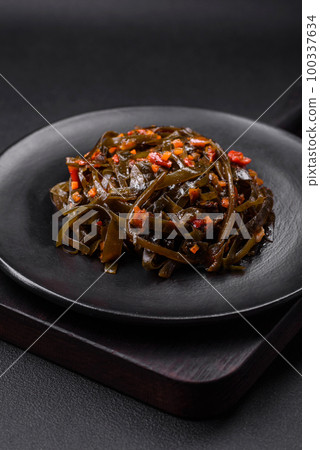 Delicious marinated seaweed with paprika, spices and salt 100337634