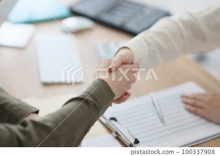 Close-up of handshake over office desk. 100337908