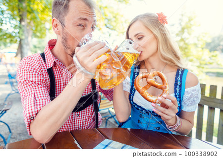Woman and man enjoying the beer garden Woman and man enjoying the beer garden 100338902