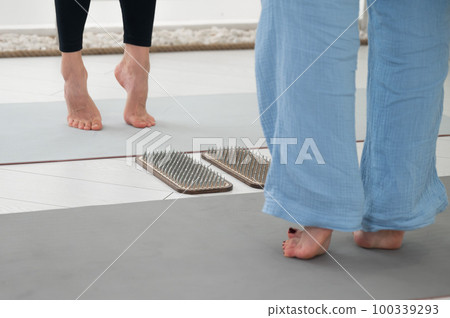 Two women stand in front of sadhu boards. Two women stand in front of sadhu boards. 100339293
