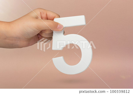 Number five in hand. Hand holding white number 5 on red background with copy space. Concept with number five. Birthday 5 years, fifth grade, five day work week Number five in hand. Hand holding white number 5 on red background with copy space. Concept with number five. Birthday 5 years, fifth grade, five day work week 100339812