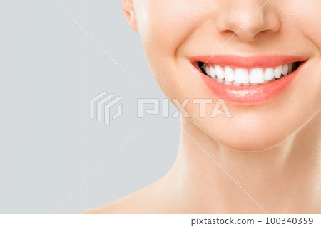 Perfect white teeth smile of a young woman. The result of the teeth whitening procedure. The image symbolizes oral care dentistry, Closeup on a white background. 100340359