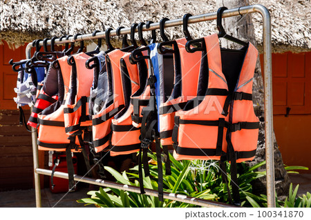 Personal flotation device. Life jacket ready to be used by tourist going on a boat trip. 100341870