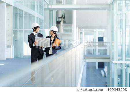 People in suits working at the work site People in suits working at the work site 100343208
