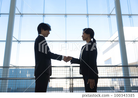 business people shaking hands 100343385