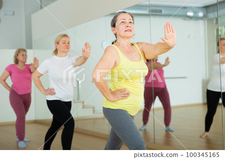 Women are dancing in a fitness room 100345165