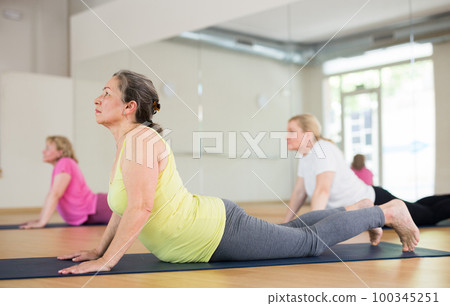 Three ladies are doing upward-facing dog pose Three ladies are doing upward-facing dog pose 100345251