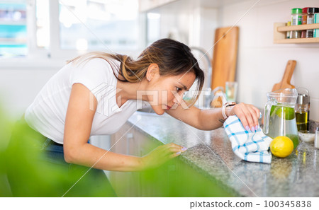 Mexican woman housewife is cleaning furniture at home 100345838