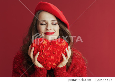 relaxed stylish 40 years old woman in red sweater and beret relaxed stylish 40 years old woman in red sweater and beret 100346347