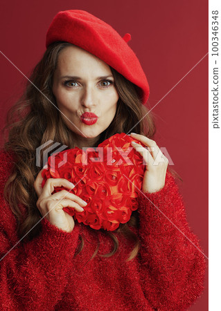 stylish woman in red sweater and beret sending kiss stylish woman in red sweater and beret sending kiss 100346348
