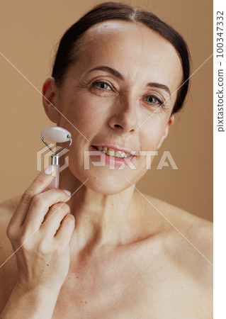 happy modern woman on beige background 100347332