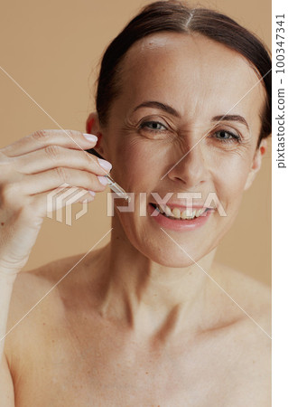 Portrait of happy modern woman isolated on beige background Portrait of happy modern woman isolated on beige background 100347341