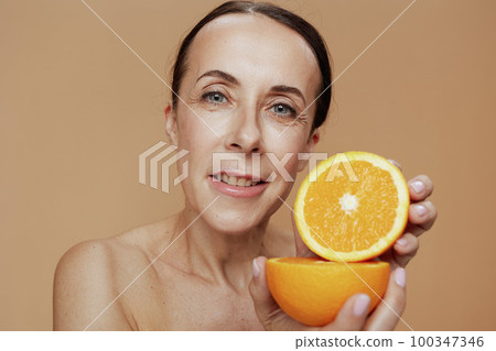 Portrait of modern woman on beige background 100347346