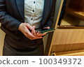 Female business looking at smartphone indoors 100349372