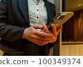 Female business looking at smartphone indoors 100349374