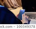 Female business looking at smartphone indoors 100349378