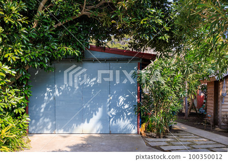 The shadow of a tree falling on the garage and its door The shadow of a tree falling on the garage and its door 100350012