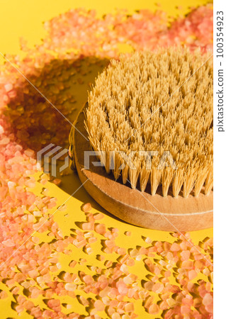 Dry massage brush with natural bristle, ecological cosmetics, home care. Natural sea salt Bamboo Brush for dry anti-cellulite massage. Spa beauty concept Dry massage brush with natural bristle, ecological cosmetics, home care. Natural sea salt Bamboo Brush for dry anti-cellulite massage. Spa beauty concept 100354923