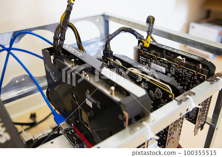 video cards in metal body frame close-up. home made mining farm. digital cryptocurrencies extraction station. 100355515
