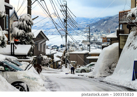 一個人在結冰的斜坡上鏟雪 一個人在結冰的斜坡上鏟雪 100355810