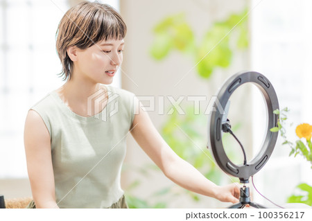 年輕女性與追隨者談論視頻分發 100356217
