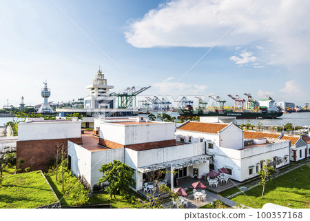 Building view of Hongmaogang Cultural Park in Kaohsiung, Taiwan. In the background are container yards and crane equipment at the Port of Kaohsiung. Building view of Hongmaogang Cultural Park in Kaohsiung, Taiwan. In the background are container yards and crane equipment at the Port of Kaohsiung. 100357168