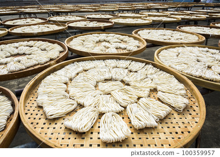 Close-up of traditional handmade noodle-making drying outdoors in Guanmiao, Tainan, Taiwan. Close-up of traditional handmade noodle-making drying outdoors in Guanmiao, Tainan, Taiwan. 100359957