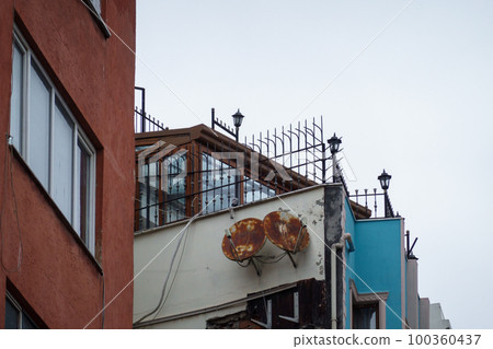 Old building with rusty satellite dishes 100360437