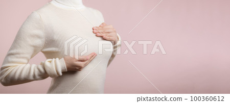 Woman hands checking lumps on her breast for signs of breast cancer on pink background. Healthcare concept. Woman hands checking lumps on her breast for signs of breast cancer on pink background. Healthcare concept. 100360612