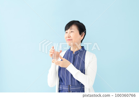 Senior woman drinking water Senior woman drinking water 100360766