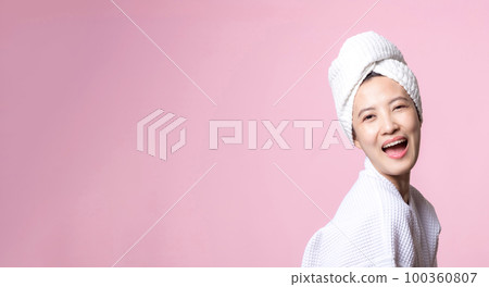 Beautiful young asian woman happy with clean face skin in towel and bathrobe, spa suit on pink background. Skincare, treatment, wellness therapy, facial care, beauty female health, cosmetology concept Beautiful young asian woman happy with clean face skin in towel and bathrobe, spa suit on pink background. Skincare, treatment, wellness therapy, facial care, beauty female health, cosmetology concept 100360807