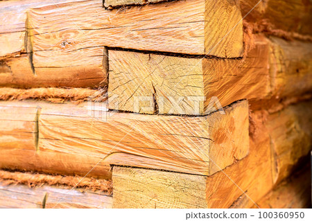log wall, corner of a wooden house and a window 100360950