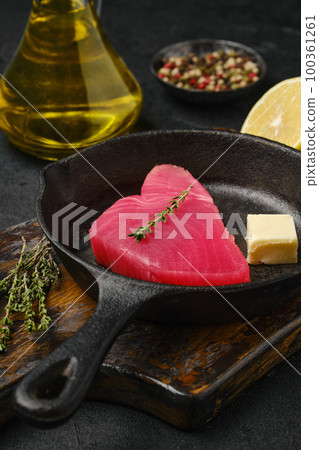 Closeup view of raw tuna slice in frying pan 100361261