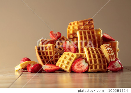 Belgian waffles with strawberries on a beige background. 100361524