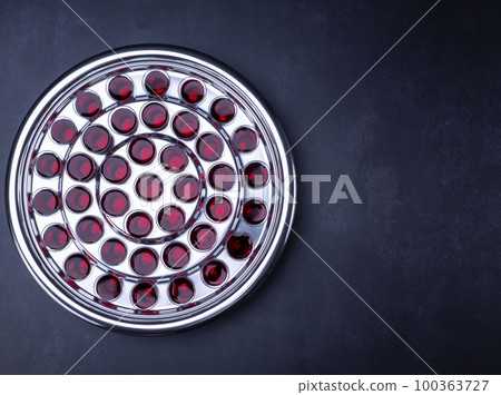 Communion glass cups with wine the symbol of Jesus Christ blood on black background Communion glass cups with wine the symbol of Jesus Christ blood on black background 100363727