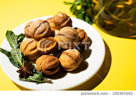 Homemade nut cookies with condensed milk on a yellow background. Homemade nut cookies with condensed milk on a yellow background. 100365092