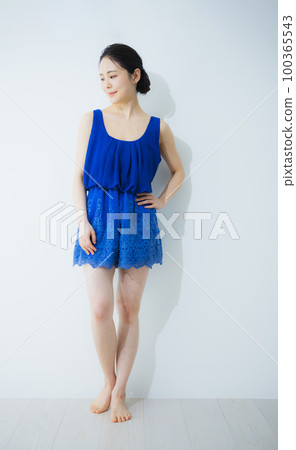 A woman in a blue dress A woman in a blue dress 100365543