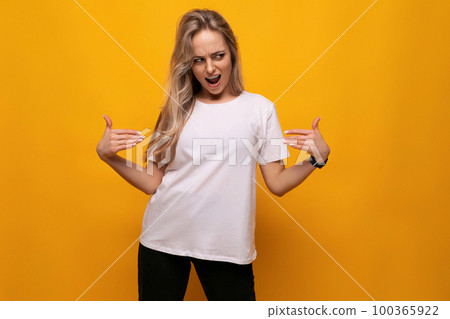 young lady in a white t-shirt mocap on a yellow background young lady in a white t-shirt mocap on a yellow background 100365922