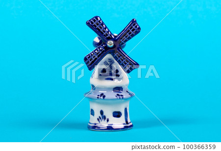 Windmill figurine from Holland, isolated on blue Windmill figurine from Holland, isolated on blue 100366359