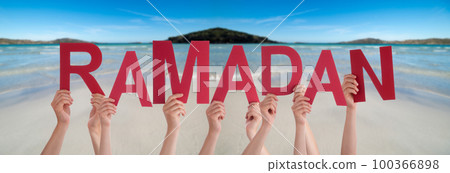 People Hands Holding Word Ramadan, Ocean Background People Hands Holding Word Ramadan, Ocean Background 100366898