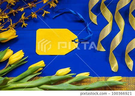 Yellow Tulip Flowers And Easter Branch, Label With Copy Space, Blue Background Yellow Tulip Flowers And Easter Branch, Label With Copy Space, Blue Background 100366921