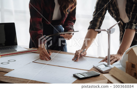 architect working on table use drawing tool on the paper plan for business architectural project. architect working on table use drawing tool on the paper plan for business architectural project. 100368884
