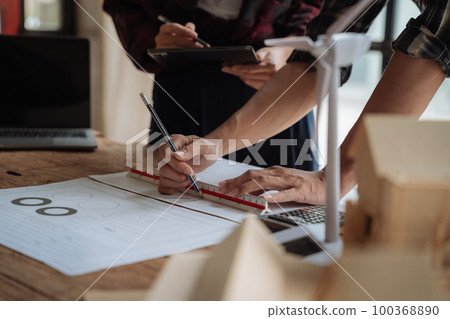 architect  working on table use drawing tool on the paper plan for business architectural project. 100368890