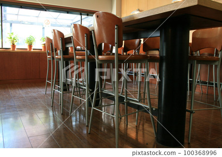 A long table and many chairs A long table and many chairs 100368996